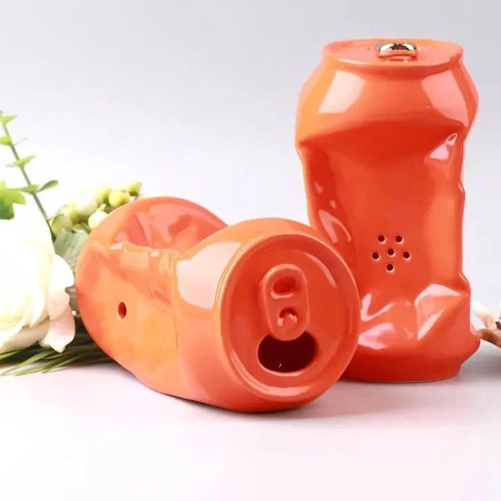 A ceramic orange soda can pipe.