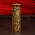 A standing carved gold brass rolling machine with engravings.