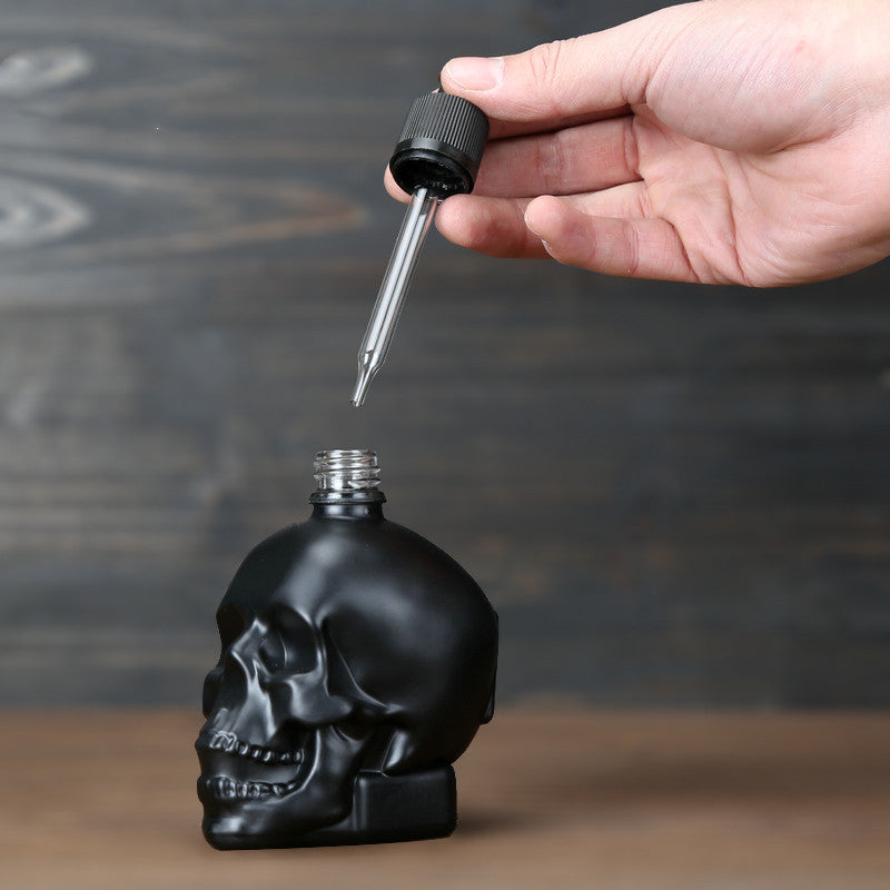 Black skull dropper on a table.